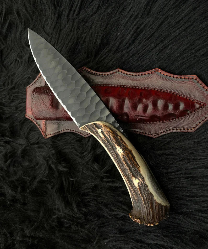Custom hunting knife with a 1095 high carbon steel blade and antler horn handle, includes leather sheath.