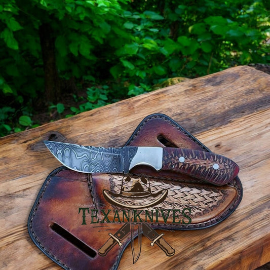 "Handcrafted Western belt knife with Damascus steel blade and pine cone resin handle"
