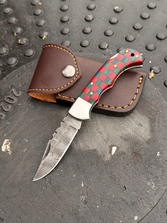 Custom folding knife with colorful handle and handmade leather sheath