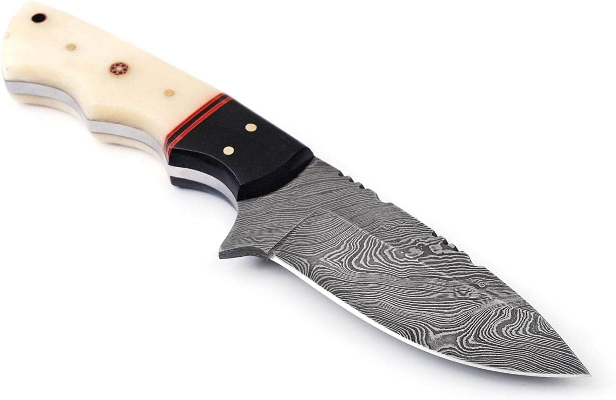 Close-up of custom handmade Damascus steel skinning knife with 4.5-inch blade, featuring a buffalo horn and camel bone handle