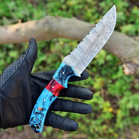 Custom 10-inch Damascus steel hunting knife with resin handle and leather sheath."