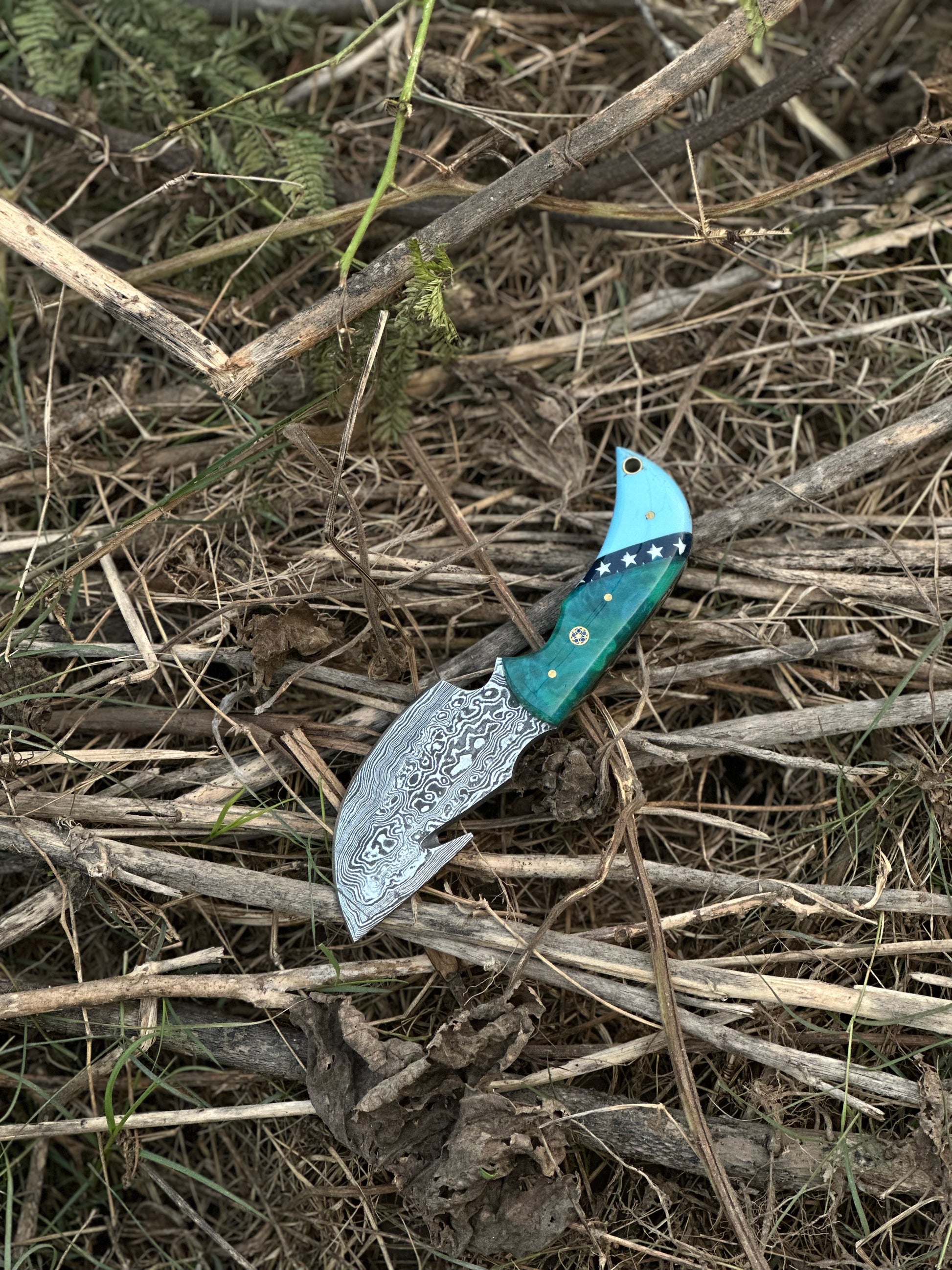 Custom Damascus guthook knife with a stylish resin handle, an excellent gift item with a leather sheath.