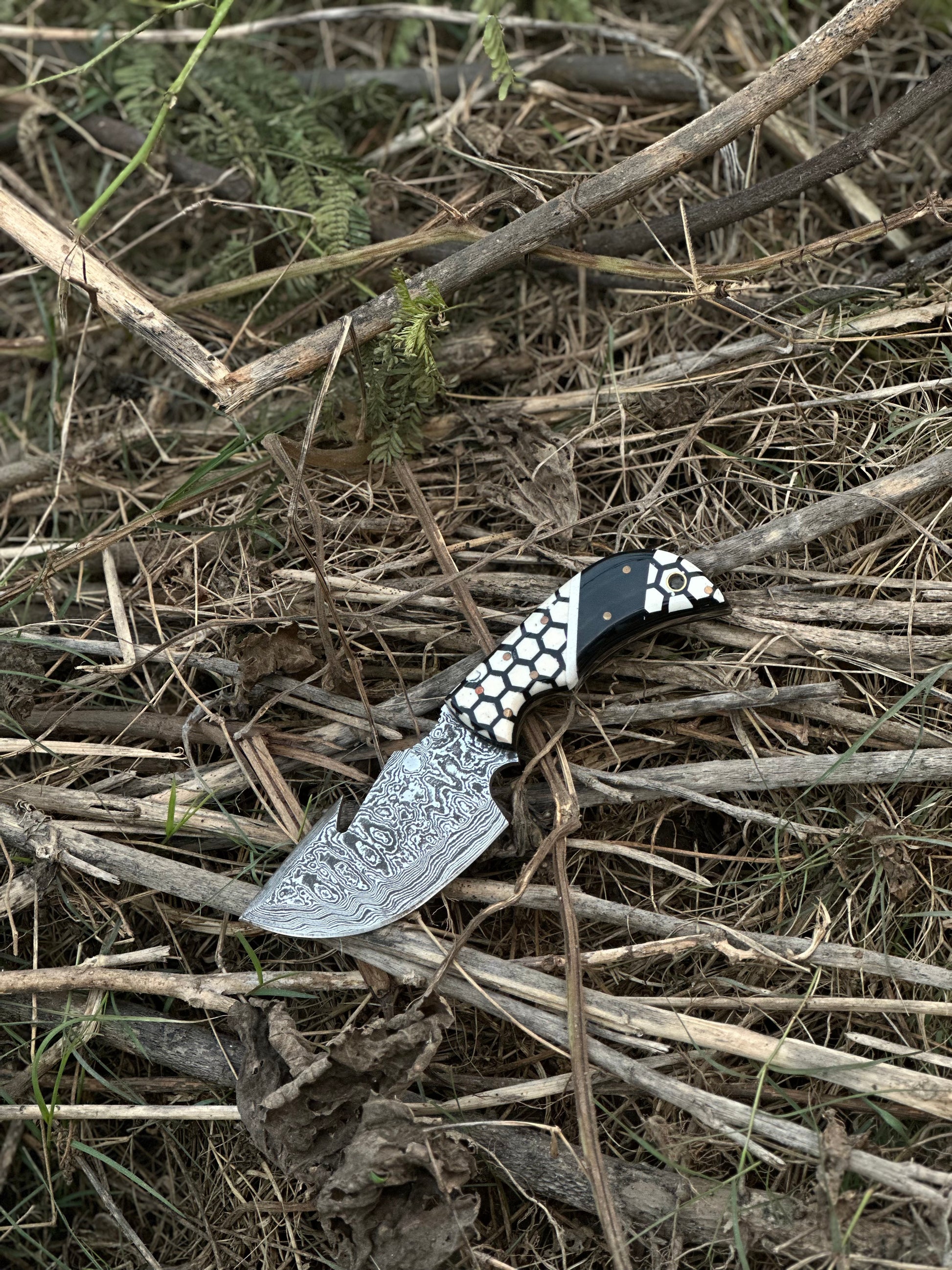 Custom Damascus guthook knife with a unique resin handle, perfect gift item with a bespoke leather sheath.