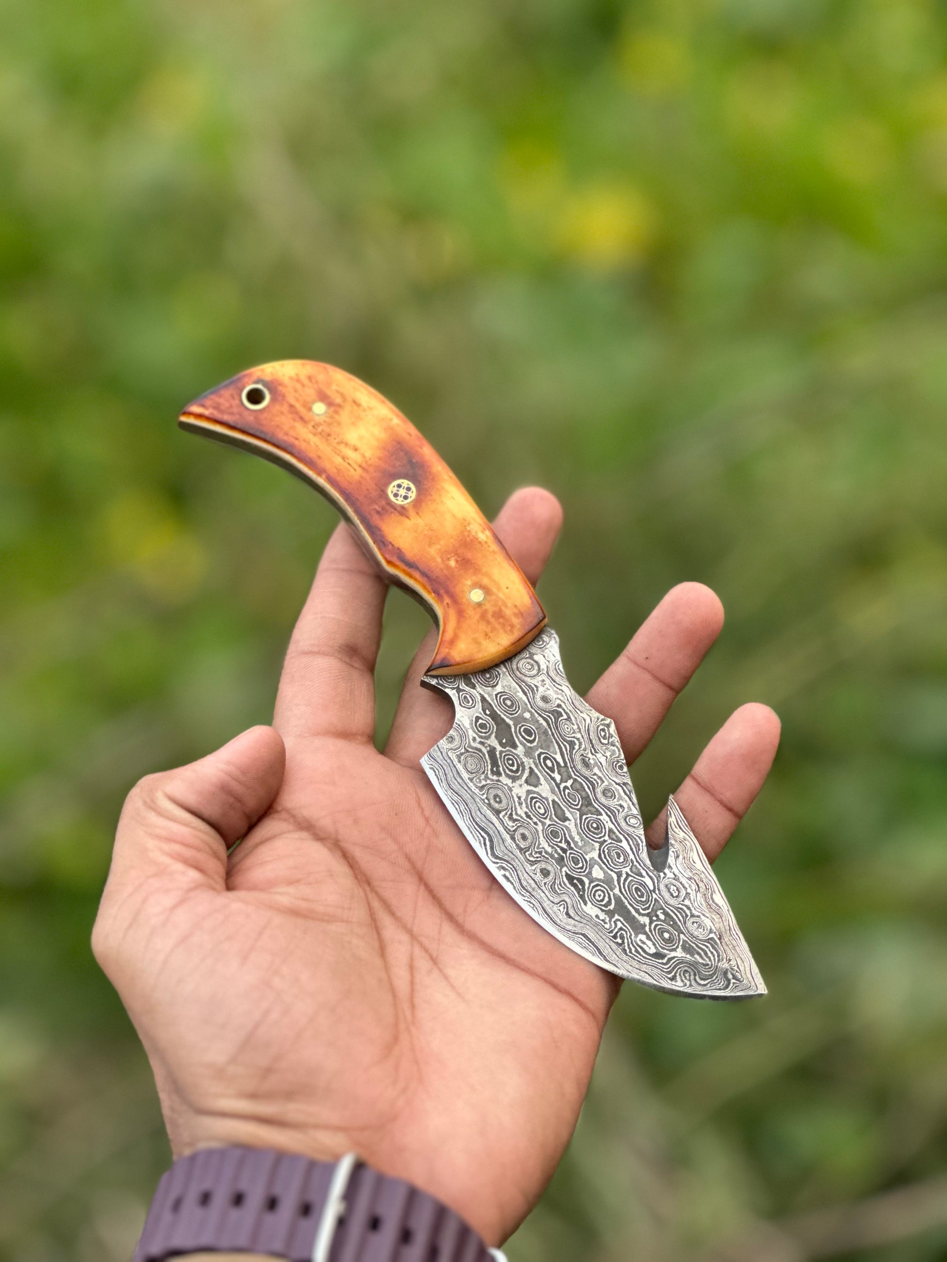 Custom Damascus guthook skinning knife with a camel bone handle, ideal gift item with leather sheath