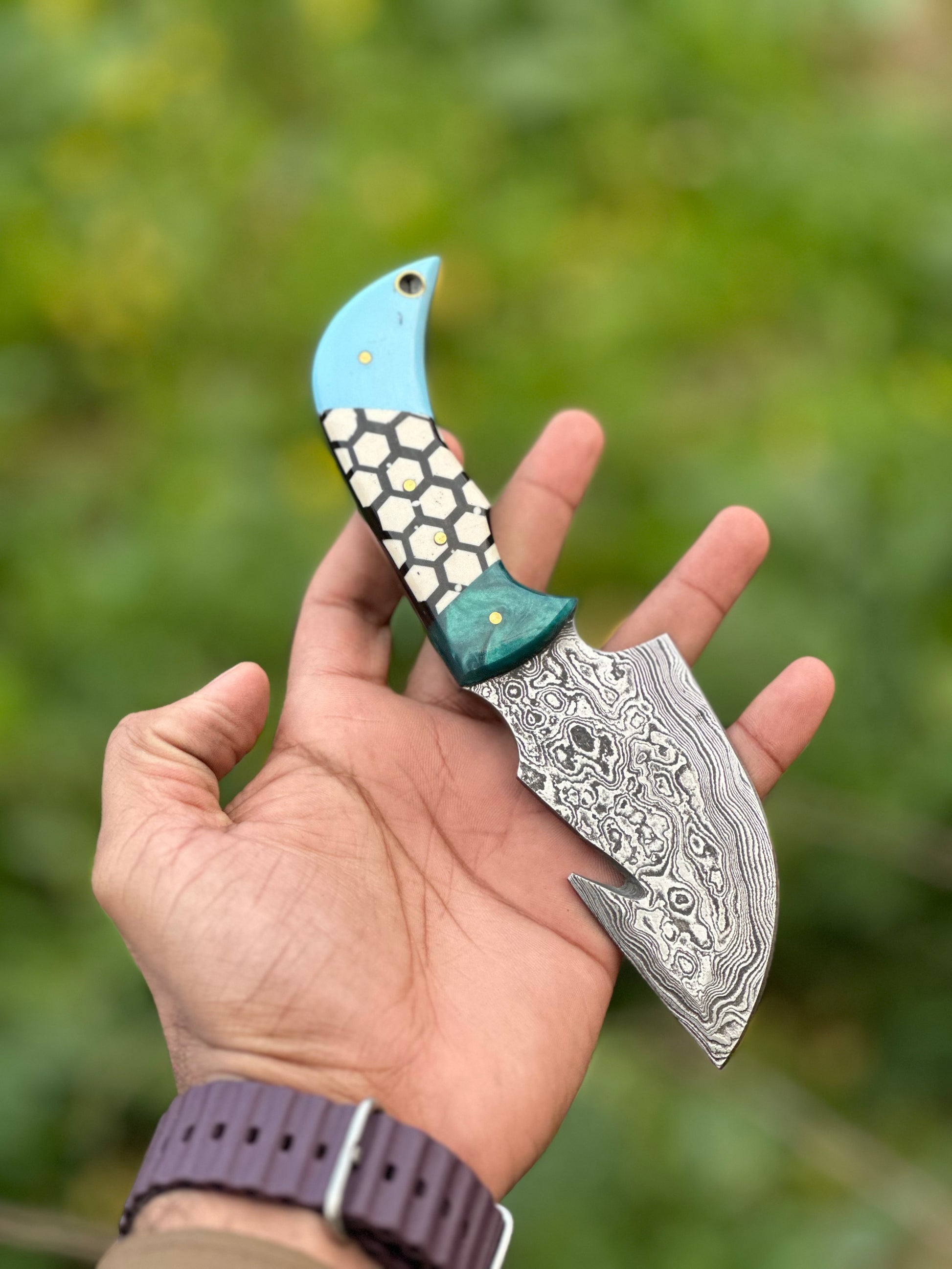 Custom Damascus guthook skinning knife with a durable resin handle, perfect gift item with leather sheath