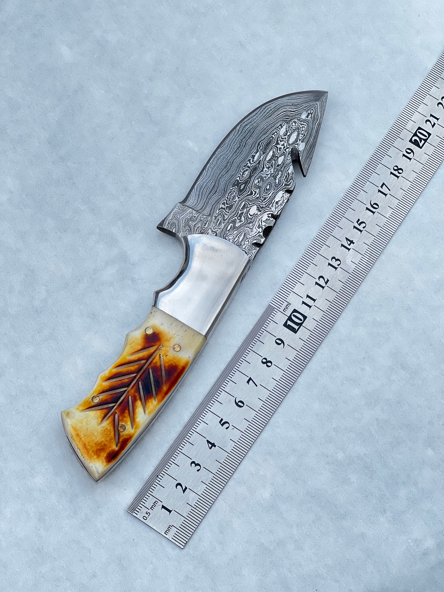 Custom Damascus pocket knife with a camel bone and rosewood handle, paired with a leather sheath