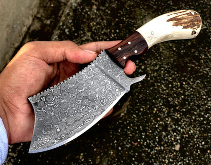 Custom Damascus steel cleaver with an antler horn handle, rosewood bolster, and leather sheath, perfect gift item