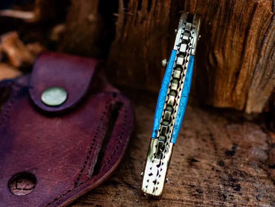 Custom Damascus steel folding knife with fish design, epoxy resin handle, and brass accents, including a leather sheath