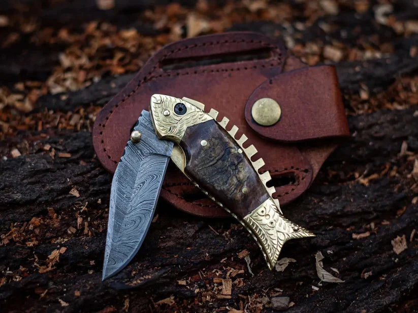 Custom Damascus steel folding knife with sheep horn and brass handle, ideal for collectors, including a leather sheath