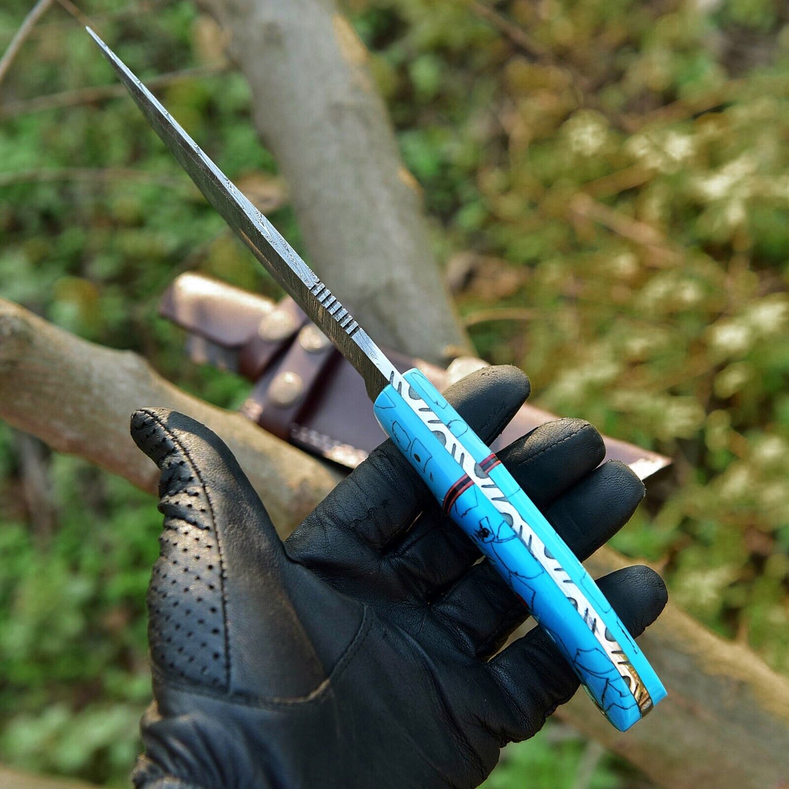 "Custom Damascus steel hunting knife featuring a 10-inch blade, stylish resin handle, and premium leather sheath."