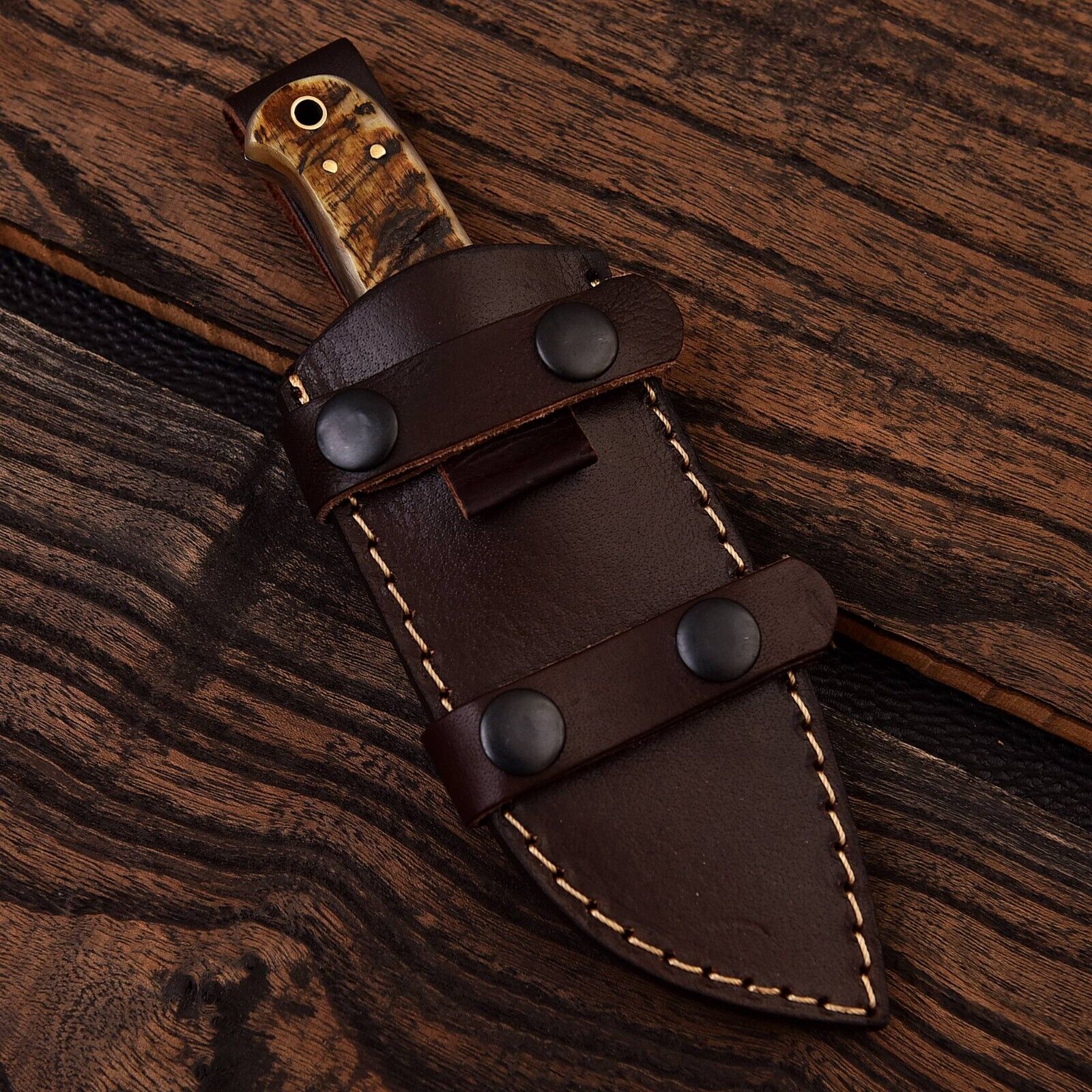 Custom Damascus steel skinning knife with sheep horn handle, featuring a 4.5-inch blade designed for precision cutting
