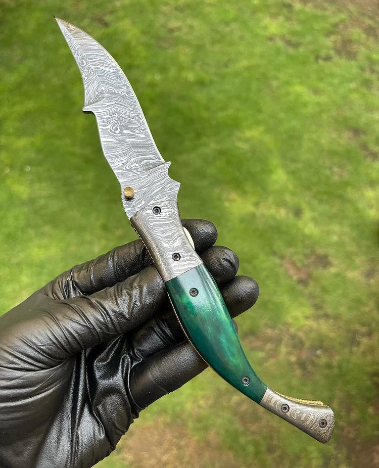 Custom handmade Damascus folding pocket knife with color bone handle and brass engraved bolster.