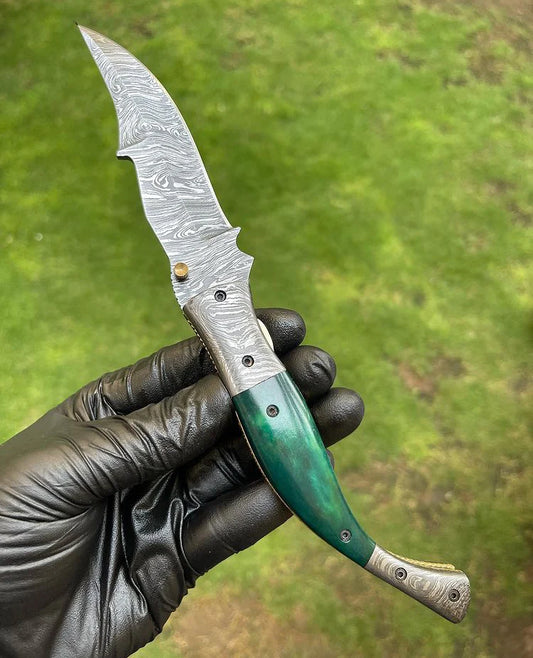 Custom handmade Damascus folding pocket knife with color bone handle and brass engraved bolster.