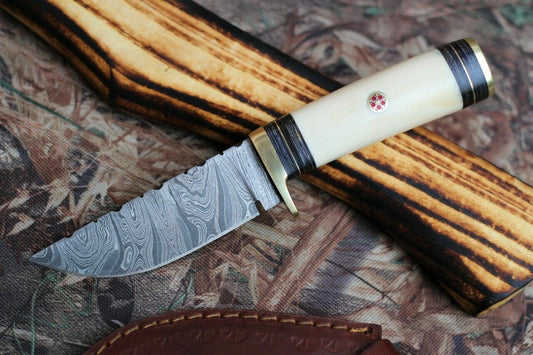 "Custom handmade Damascus steel camping knife with a 3-inch blade and camel bone handle."
