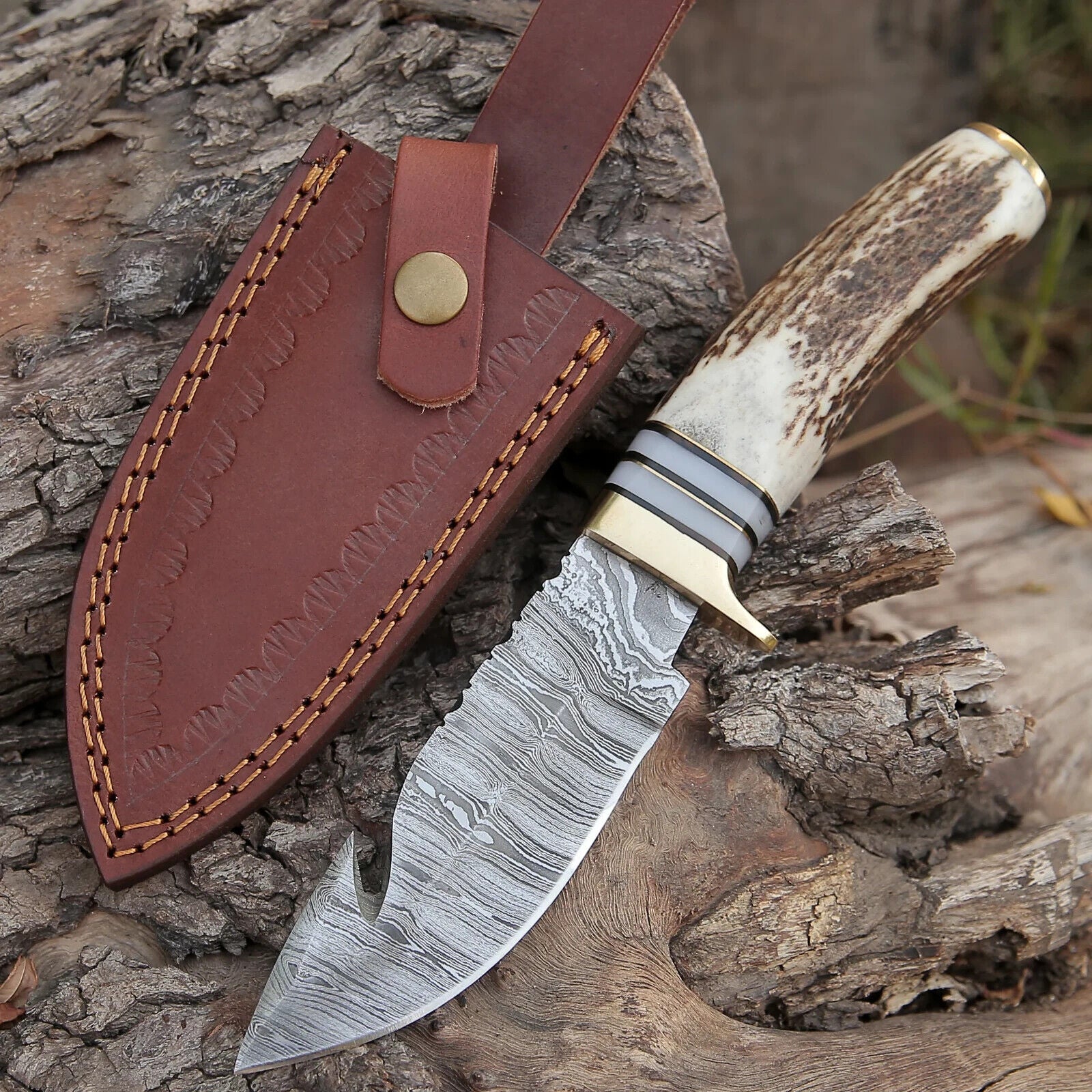 "Custom handmade Damascus steel guthook skinning knife with a 9-inch blade and stag horn handle."