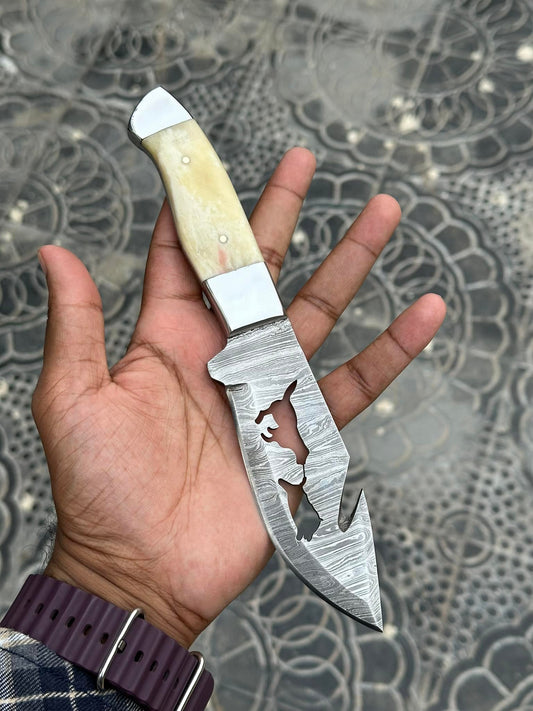 Custom handmade Damascus steel knife with 5-inch blade, camel bone handle, steel bolster, and leather belt sheath for convenient carrying
