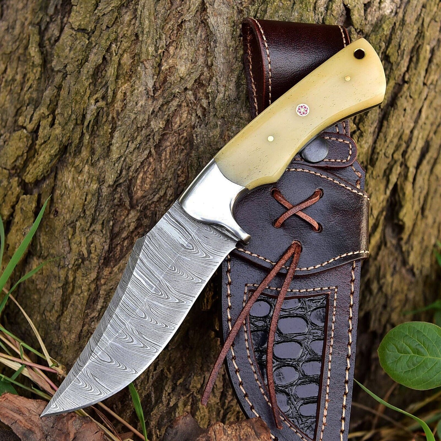 Custom handmade Damascus steel skinner knife with a 5-inch blade, featuring a camel bone handle and steel bolster, ideal for skinning and outdoor use