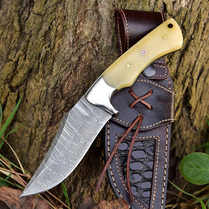 Custom handmade Damascus steel skinner knife with a 5-inch blade, featuring a camel bone handle and steel bolster, ideal for skinning and outdoor use