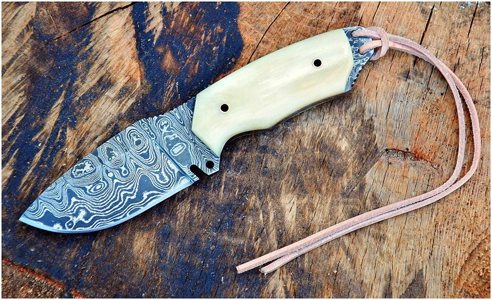 Custom handmade Damascus steel skinning knife with a 4-inch blade and camel bone handle, ideal for hunting, skinning, and outdoor tasks