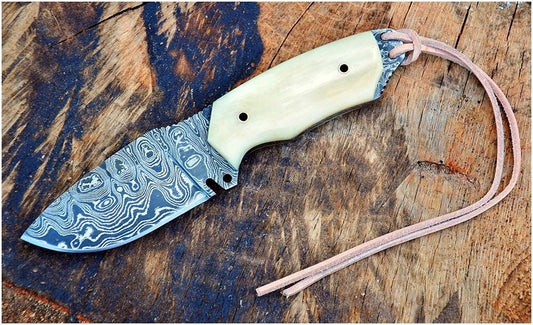 Custom handmade Damascus steel skinning knife with a 4-inch blade and camel bone handle, ideal for hunting, skinning, and outdoor tasks