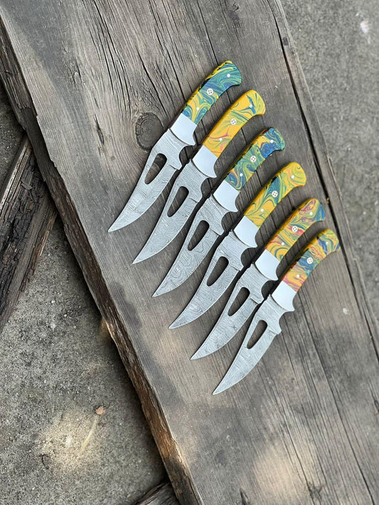 Custom handmade Damascus steel skinning knife with a 4-inch blade, resin handle, steel bolster, and leather sheath, perfect for hunting and outdoor use.