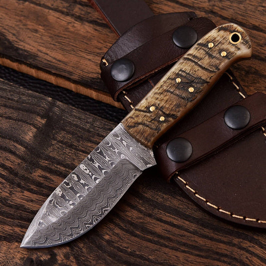Custom handmade Damascus steel skinning knife with a 4.5-inch blade and a sheep horn handle, ideal for precision skinning and outdoor use.