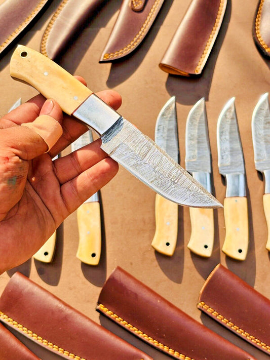 Custom handmade skinner knife with 4.5-inch Damascus steel blade, camel bone handle, and steel bolster