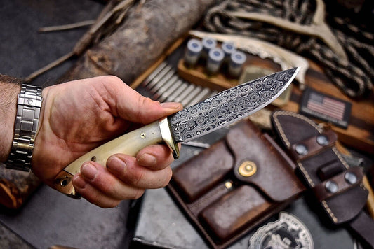Custom handmade skinning knife with 4.5-inch Damascus steel blade and camel bone handle featuring brass bolster, includes leather sheath for hunters and collectors
