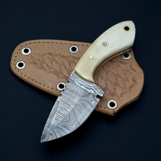 Custom handmade skinning knife with a 3-inch Damascus steel blade and a camel bone handle, featuring a leather sheath for safe storage