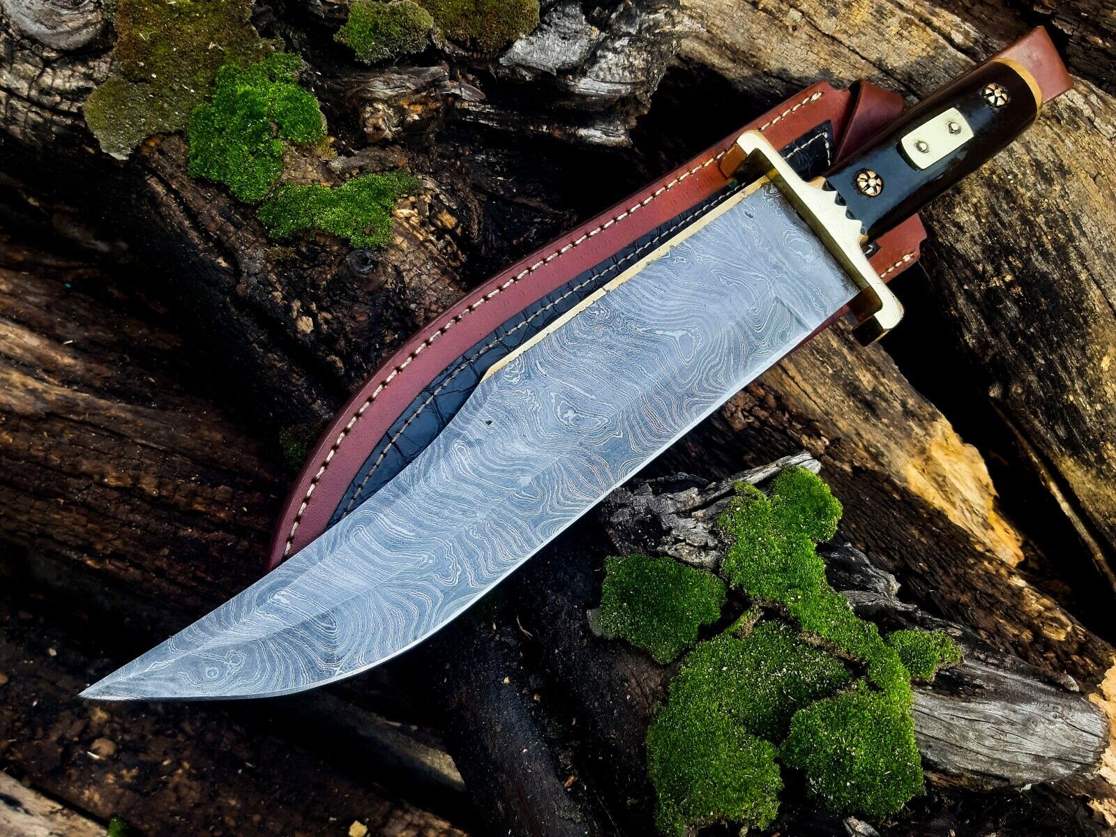 "Damascus steel cowboy bowie knife featuring a buffalo horn handle and brass guard"