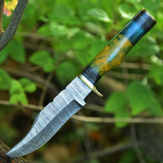 Damascus steel hunting knife with 10" blade and brass guard.