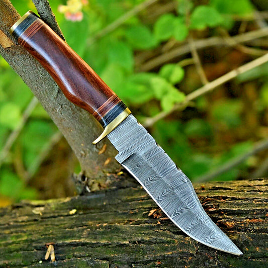 Damascus steel hunting knife with 10" blade, brass guard, and resin pakkawood handle.