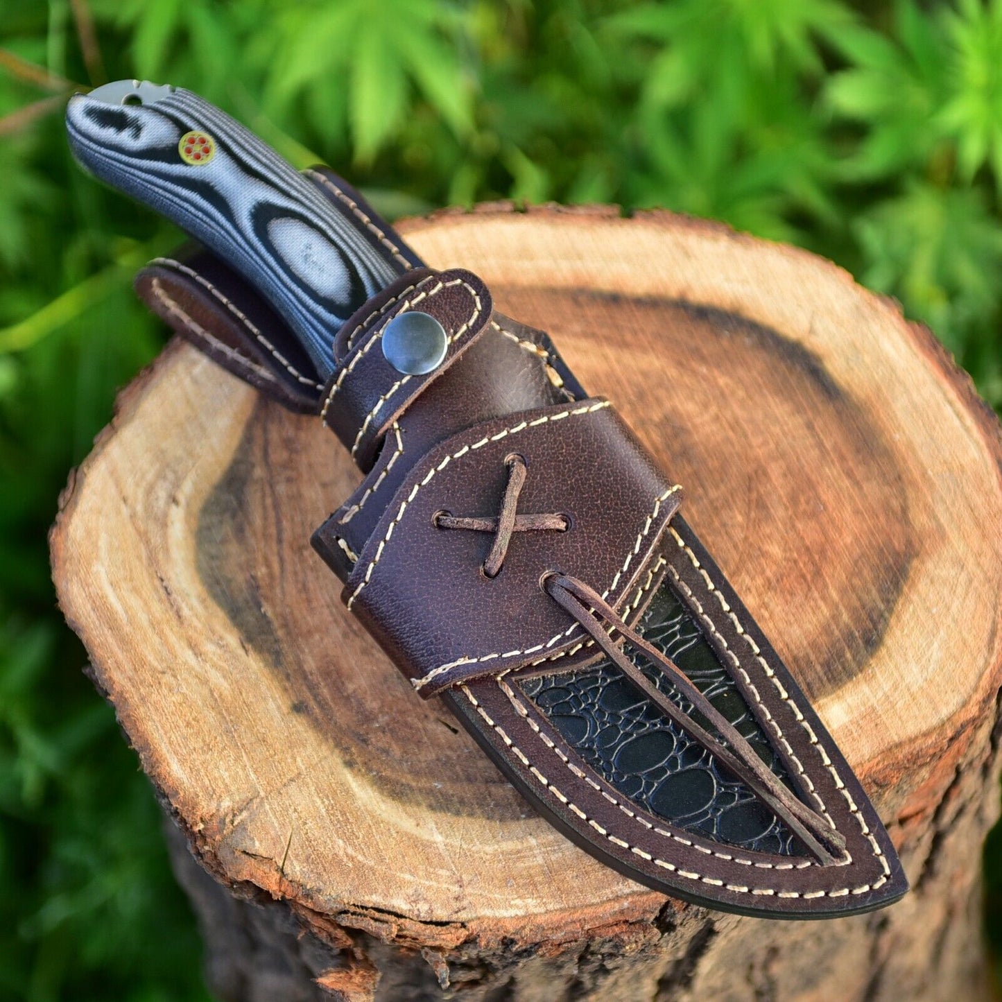 Damascus steel hunting knife with G10 handle, featuring a leather sheath, great as a gift item
