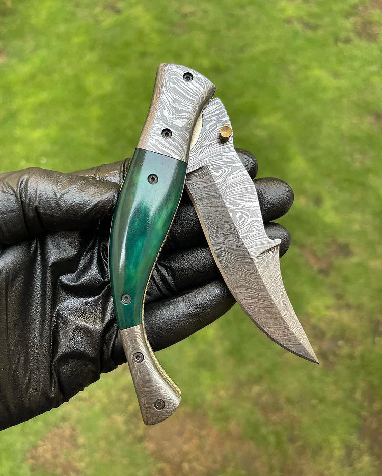 EDC folding pocket knife with Damascus blade, brass bolster, and colorful bone handle, leather sheath included