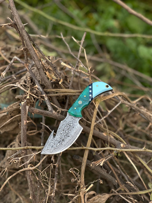 Elite custom handmade Damascus steel guthook knife with a resin handle and leather sheath.