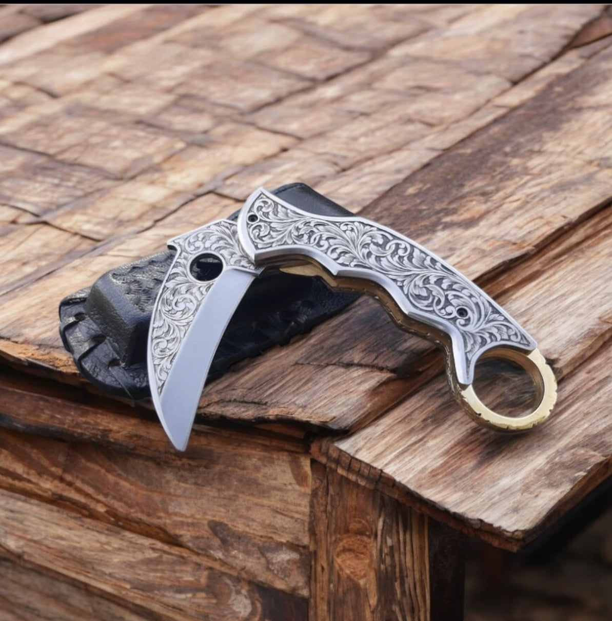 "Hand-engraved J2 steel folding knife with engraved handle and leather case."

