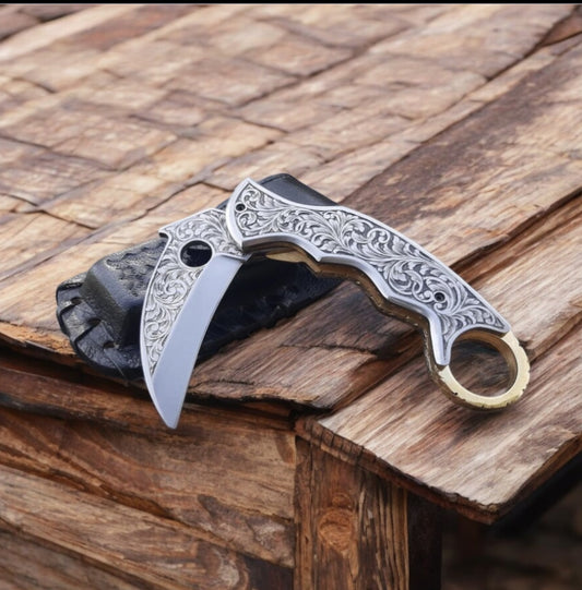 "Hand-engraved J2 steel folding knife with engraved handle and leather case."

