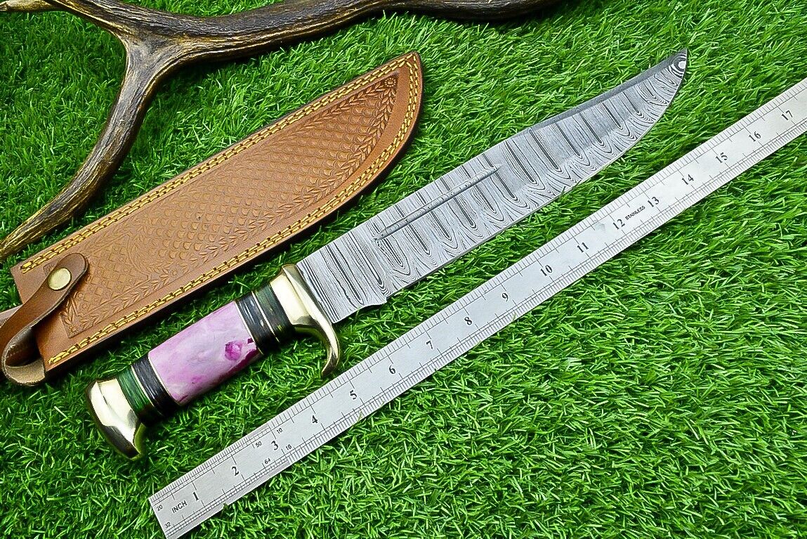 "Hand-forged Damascus steel bowie knife with brass guard and leather sheath"