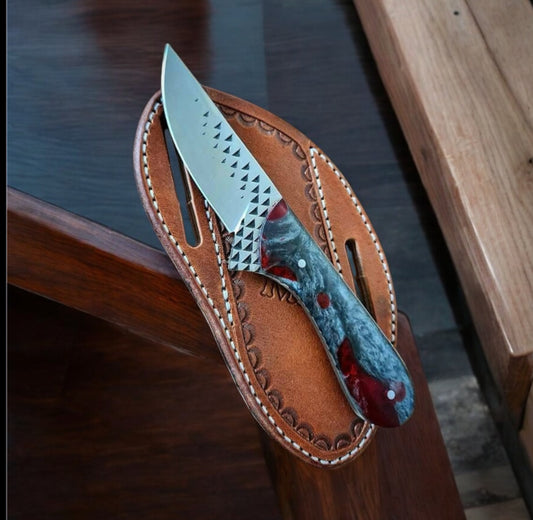"Hand-forged cowboy fixed blade knife with rasp tool steel blade and resin handle, shown with leather belt sheath."

