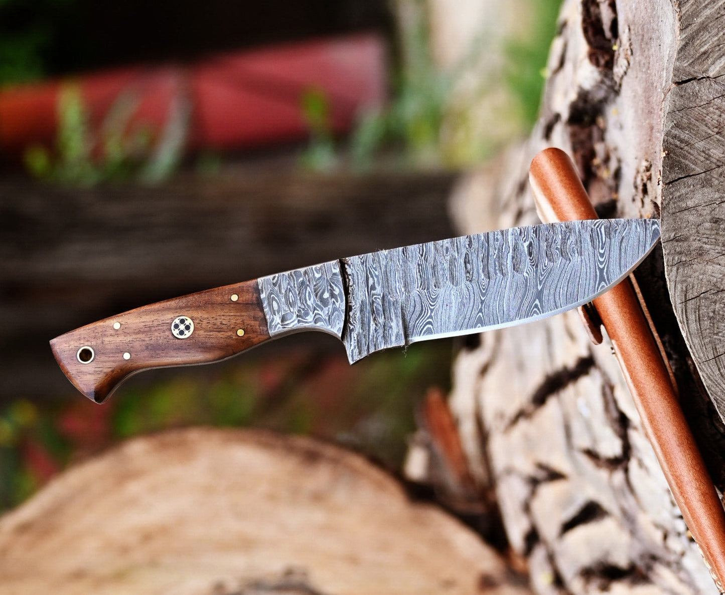 Handcrafted Damascus skinning knife with 5-inch blade and rosewood handle, designed for outdoor use and precision cuts