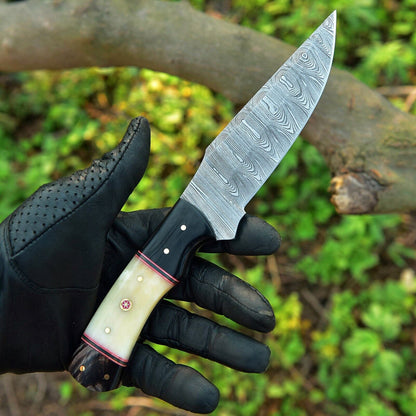 Handcrafted Damascus steel skinning knife set featuring a 4.5-inch blade and durable camel bone and resin handle with leather sheath