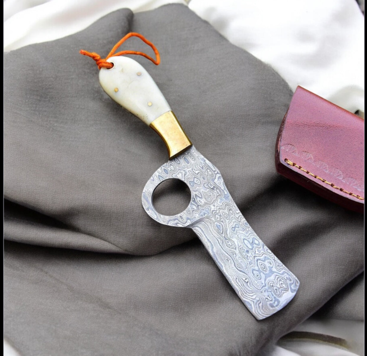"Handcrafted Western Belt Knife with a sharp Damascus steel blade, camel bone handle, and brass bolster."

