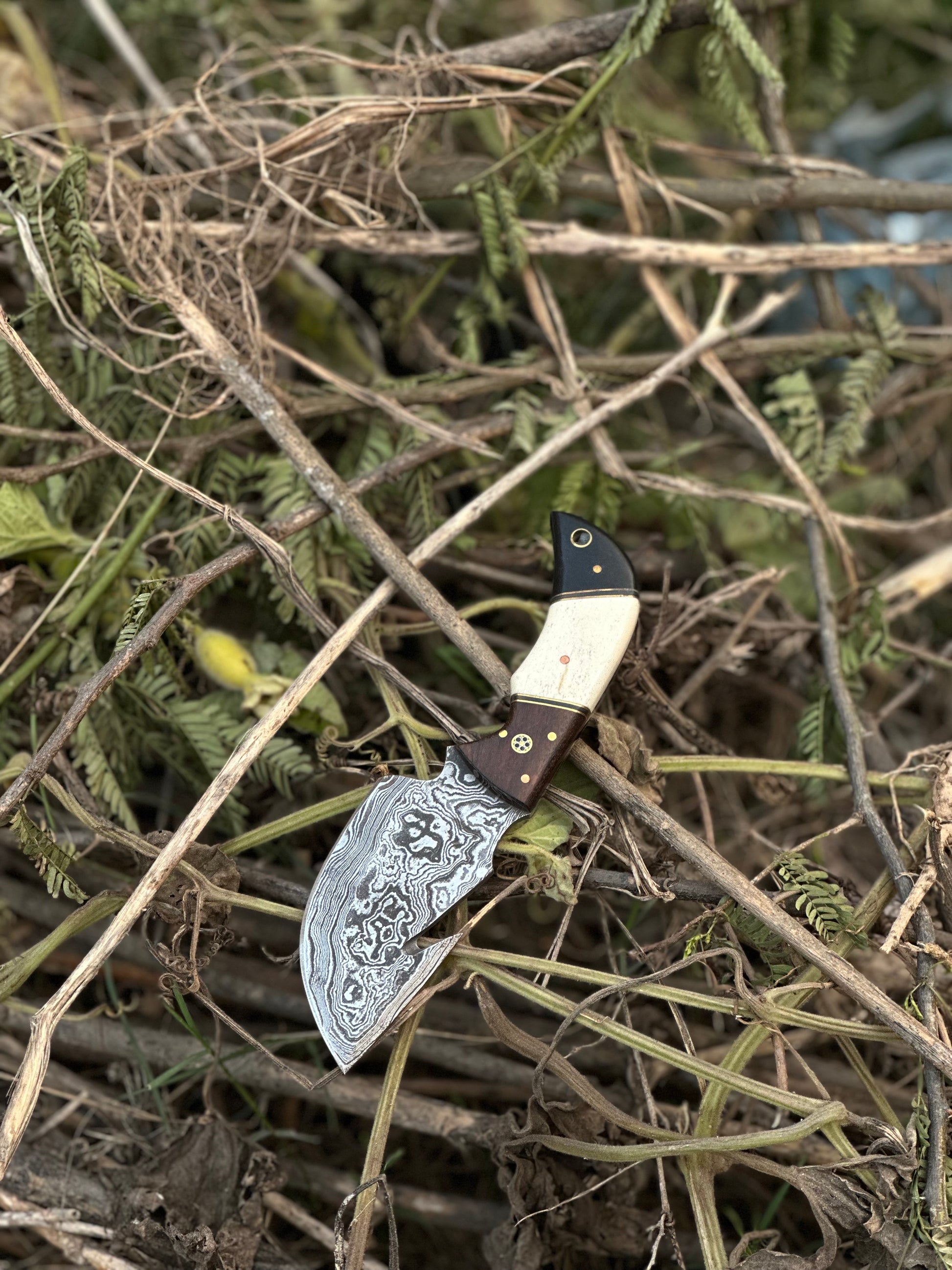 Handmade Damascus steel guthook knife with a rosewood, camel bone, and black sheet handle, ideal for skinning and gifting