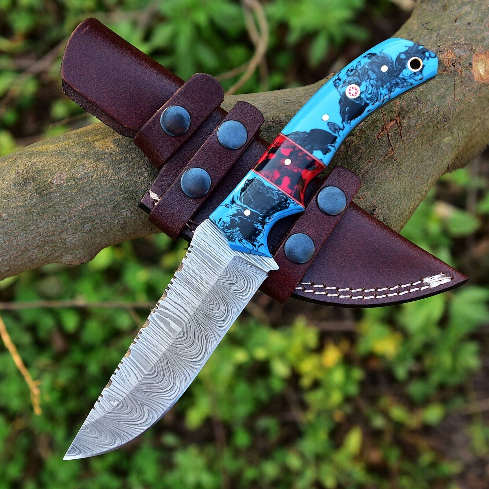 Handmade Damascus steel knife with 10-inch blade, resin handle, and protective leather sheath for outdoor use