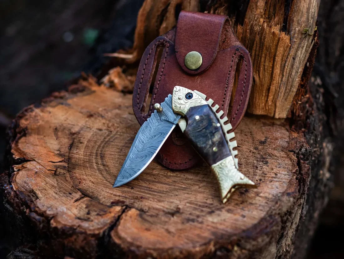 Handmade fish style Damascus steel knife with a genuine sheep horn handle and brass accents, housed in a handcrafted leather sheath