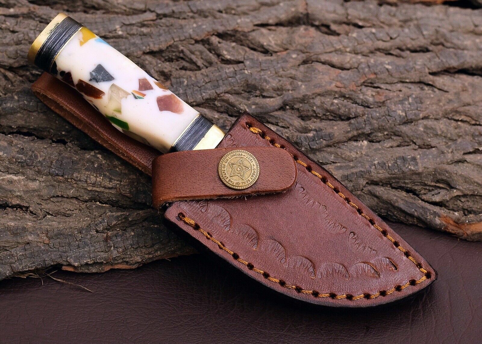 "Outdoor knife featuring pakkawood and resin handle with a brass guard."
