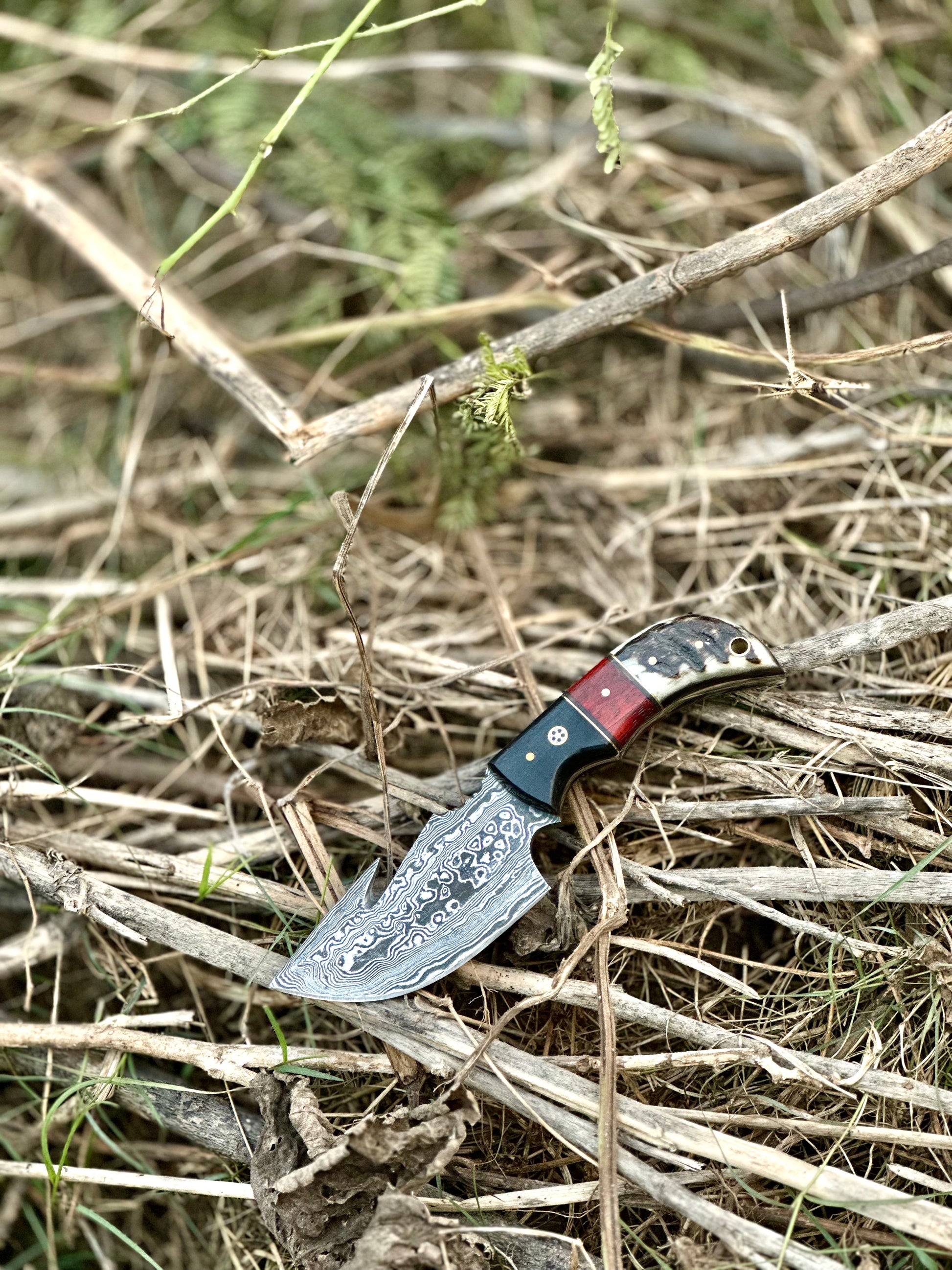 Premium custom handmade Damascus steel guthook knife with a resin handle and leather sheath