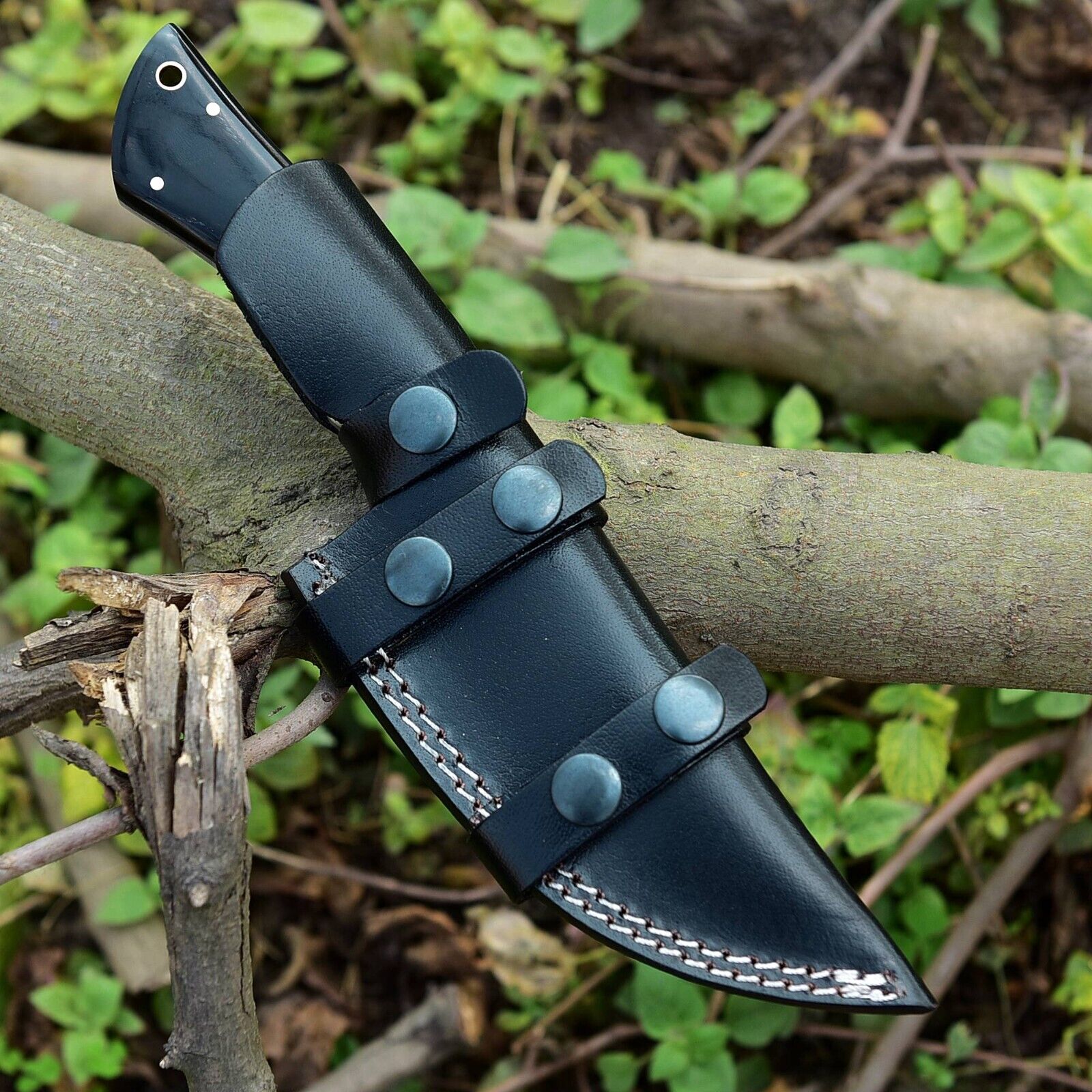 Premium skinning knife with handcrafted Damascus steel blade and buffalo horn/camel bone handle, perfect for hunters and collectors