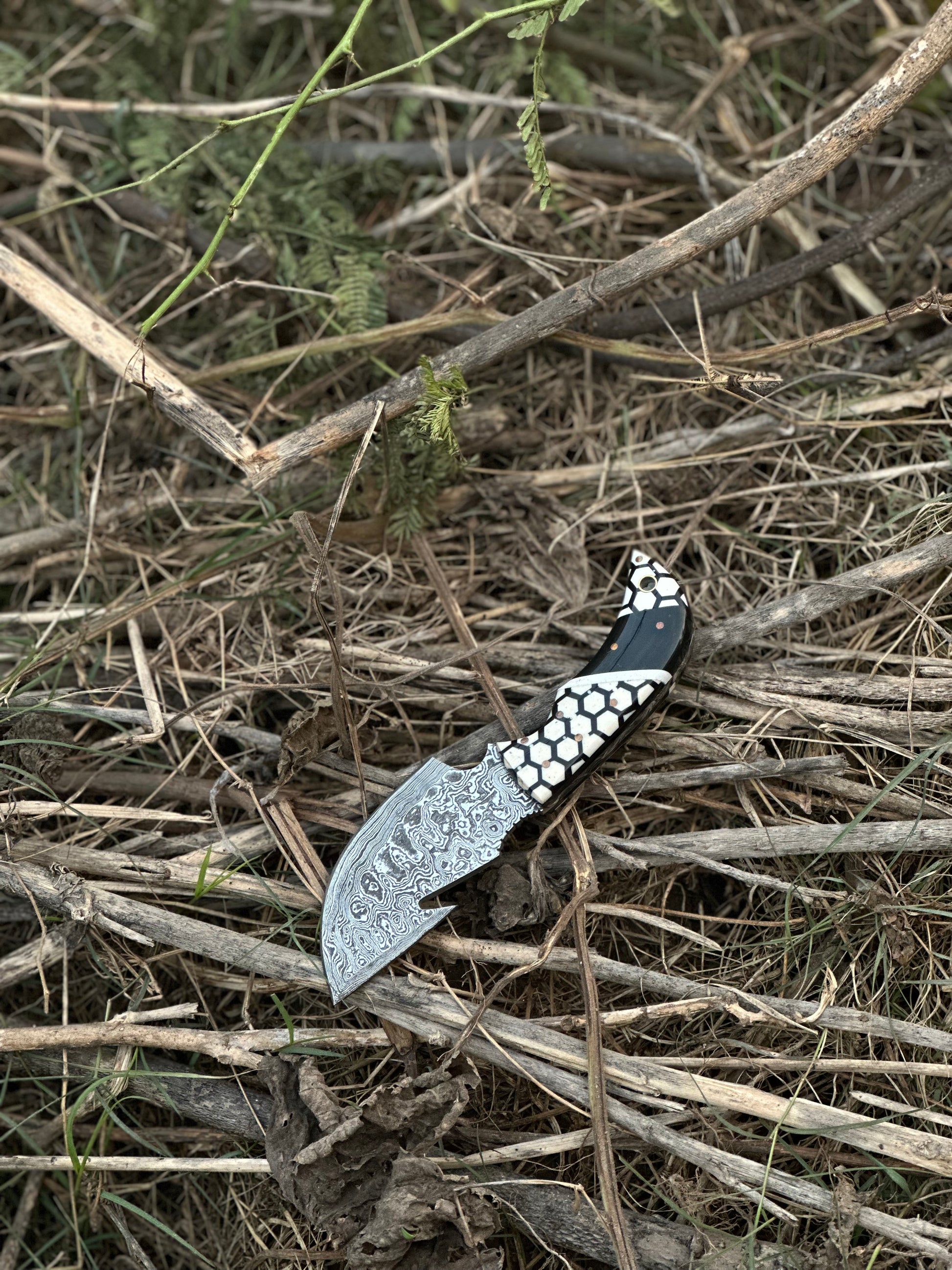  custom handmade Damascus steel guthook knife with a unique resin handle and leather sheath